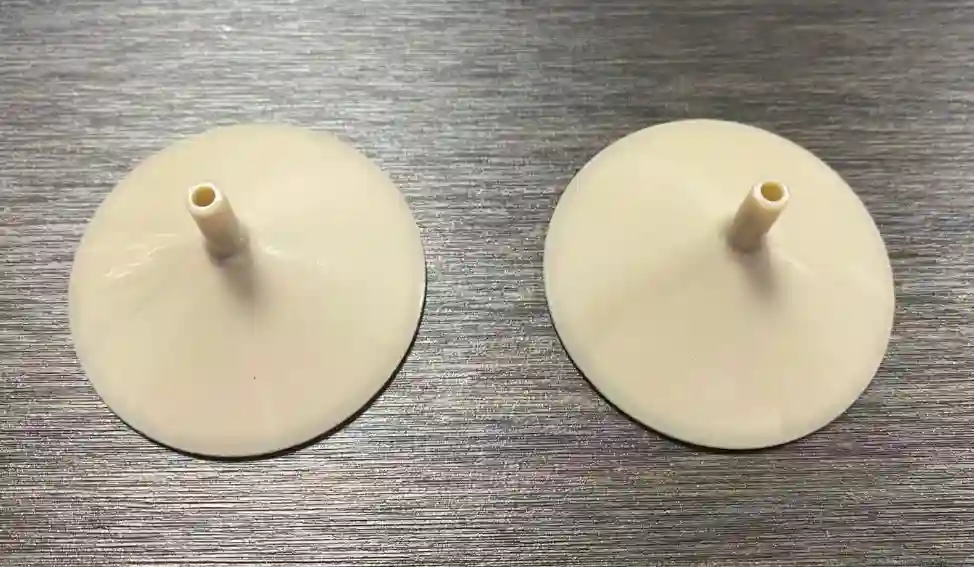 Injection molded PEEK cap component samples